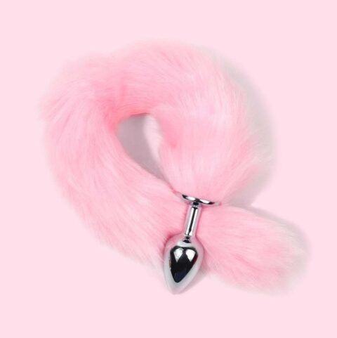 Pink faux fur tail plug with smooth silver metal base on soft pastel background