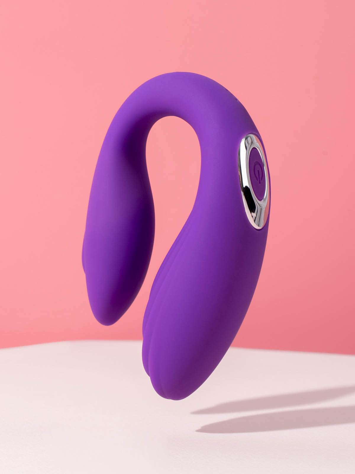 Sleek purple clitoral vibrator made of medical grade silicone on a white background