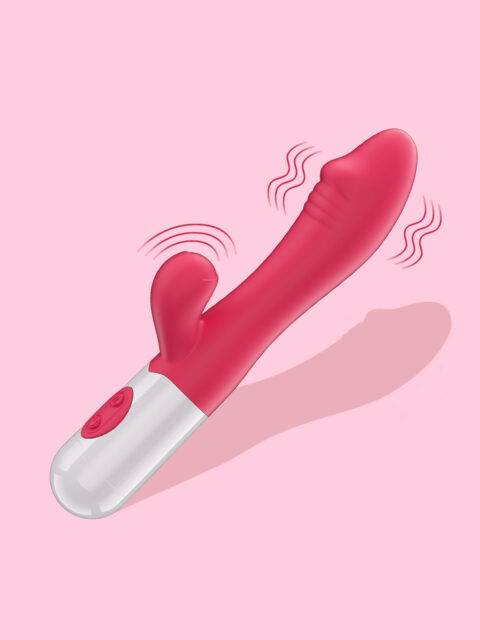 Angled product shot of a fuchsia pink medical-grade silicone dual stimulation rabbit vibrator with a silver handle, showing motion lines to indicate vibration on a light pink background.