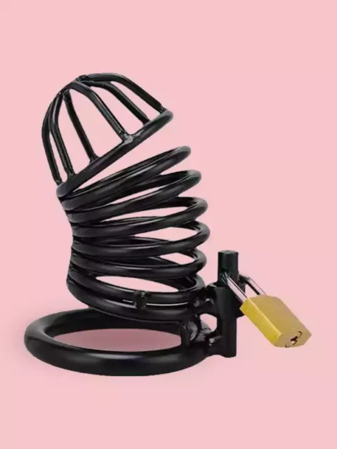 A black stainless steel male chastity cage and locking base ring, secured with a small brass padlock, isolated against a solid light pink background