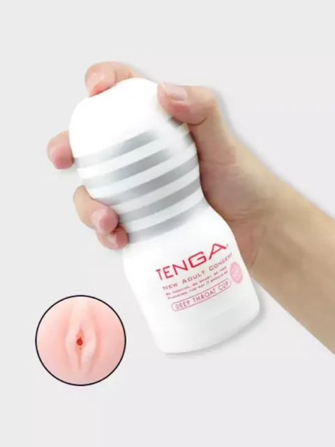 Hand holding the white Tenga Deep Throat Cup masturbator with silver ribbed grip bands